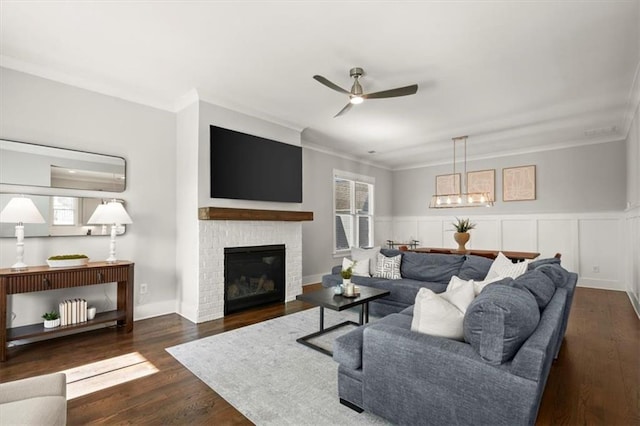 2005 Haley Walk, Woodstock, GA 30188 - living room with ornamental molding, ceiling fan, wood finished floors, a brick fireplace, and a wainscoted wall