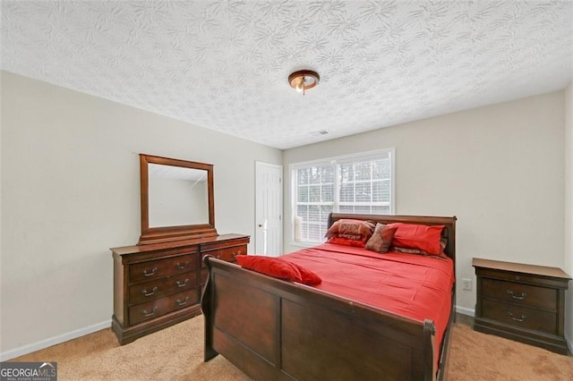 carpeted bedroom featuring a textured ceiling