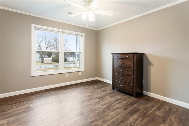 unfurnished bedroom with dark wood-style floors, a ceiling fan, crown molding, and baseboards