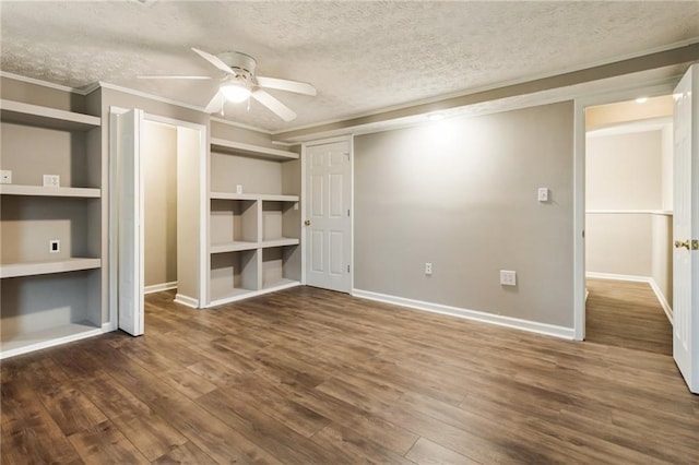 unfurnished bedroom featuring ornamental molding, a textured ceiling, baseboards, and wood finished floors