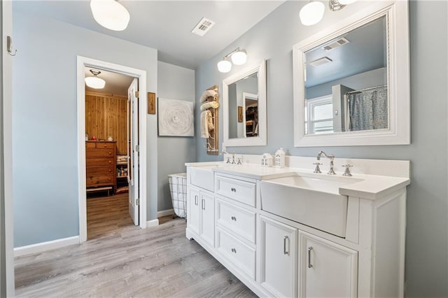 5102 Yellow Stone Dr, Flowery Branch, GA 30542 - full bath with double vanity, wood finished floors, and baseboards