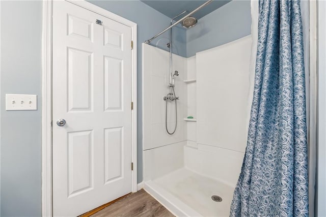 5102 Yellow Stone Dr, Flowery Branch, GA 30542 - bathroom with curtained shower and wood finished floors