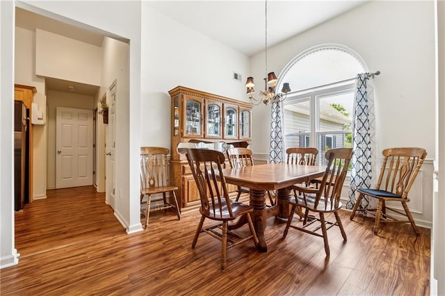 5102 Yellow Stone Dr, Flowery Branch, GA 30542 - dining area with a high ceiling, wood finished floors, a chandelier, and baseboards