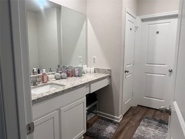 bathroom with hardwood / wood-style floors and vanity