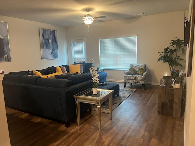 living room with dark hardwood / wood-style flooring and ceiling fan