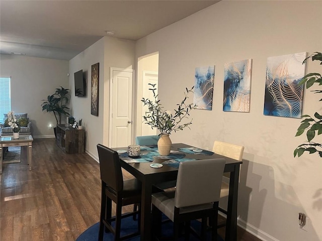 dining area with dark hardwood / wood-style floors