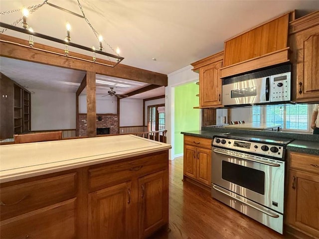 8710 Mount Rushmore Dr, Johns Creek, GA 30022 - kitchen featuring stainless steel range oven, ceiling fan, brown cabinets, dark wood-style floors, and a brick fireplace