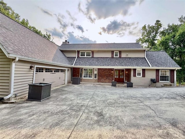 8710 Mount Rushmore Dr, Johns Creek, GA 30022 - traditional-style home featuring driveway, a chimney, french doors, a garage, and a shingled roof