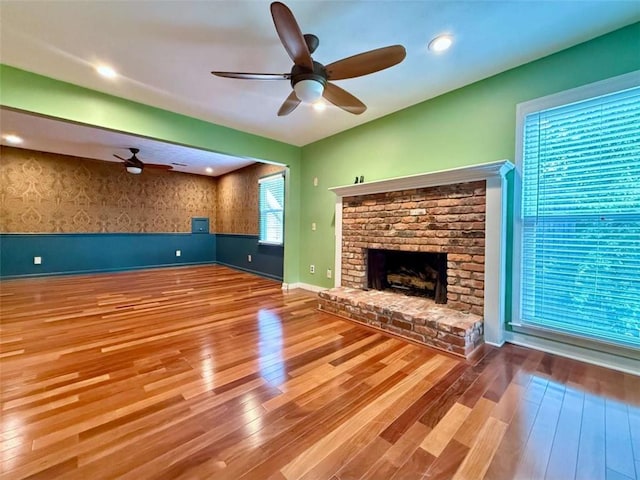 8710 Mount Rushmore Dr, Johns Creek, GA 30022 - unfurnished living room with a ceiling fan, hardwood / wood-style floors, a fireplace, baseboards, and wallpapered walls