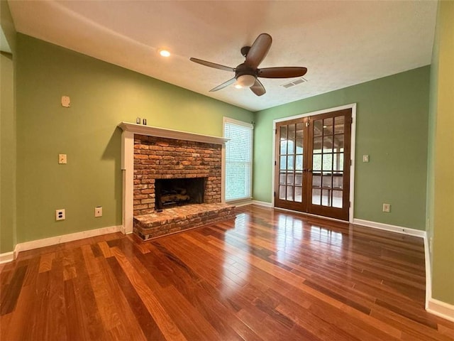 8710 Mount Rushmore Dr, Johns Creek, GA 30022 - unfurnished living room with wood finished floors, a ceiling fan, baseboards, a brick fireplace, and french doors