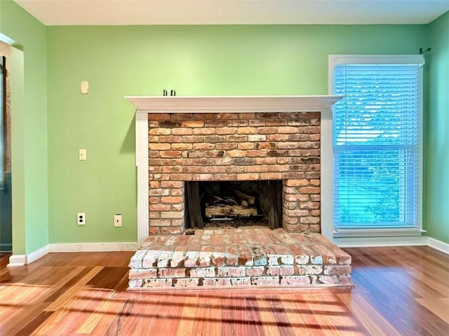 8710 Mount Rushmore Dr, Johns Creek, GA 30022 - detailed view of wood finished floors, baseboards, and a brick fireplace