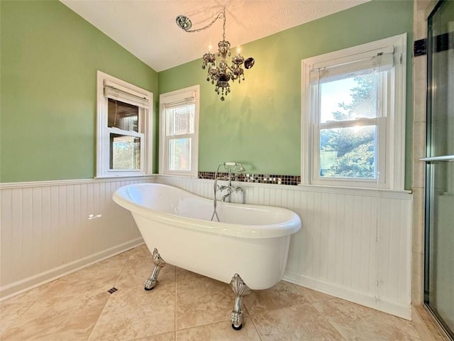 8710 Mount Rushmore Dr, Johns Creek, GA 30022 - bathroom with wainscoting, healthy amount of natural light, a freestanding tub, a stall shower, and a chandelier