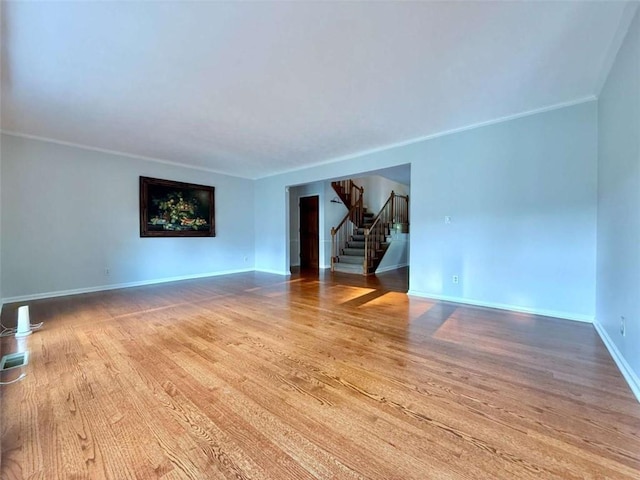 8710 Mount Rushmore Dr, Johns Creek, GA 30022 - spare room with stairway, light wood finished floors, and baseboards