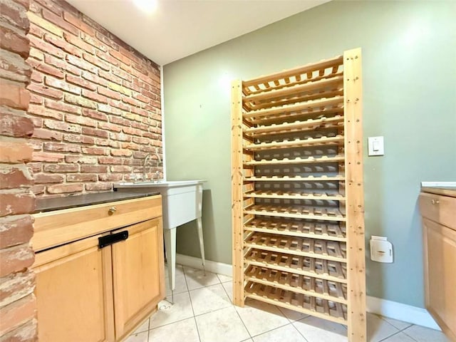 8710 Mount Rushmore Dr, Johns Creek, GA 30022 - wine cellar with brick wall, light tile patterned flooring, and baseboards