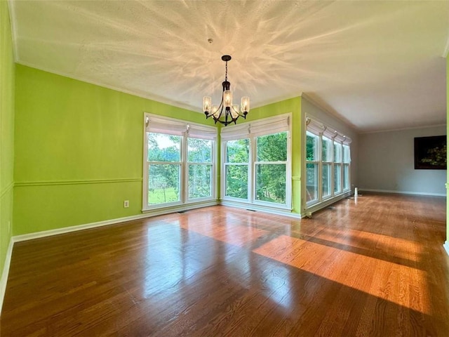 8710 Mount Rushmore Dr, Johns Creek, GA 30022 - unfurnished room with a chandelier, healthy amount of natural light, wood finished floors, baseboards, and crown molding