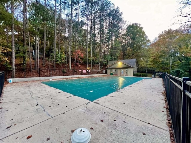 8710 Mount Rushmore Dr, Johns Creek, GA 30022 - view of pool with a patio area and view of wooded area