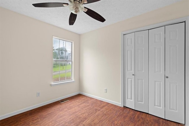35 Lady Morgan Ln, Dallas, GA 30157 - unfurnished bedroom with a textured ceiling, wood finished floors, baseboards, a closet, and a ceiling fan