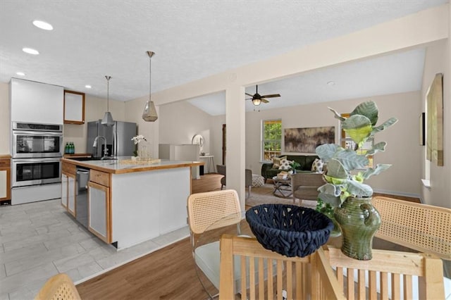 35 Lady Morgan Ln, Dallas, GA 30157 - kitchen featuring stainless steel appliances, recessed lighting, light countertops, a center island with sink, and hanging light fixtures