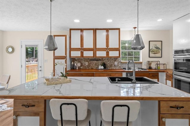 35 Lady Morgan Ln, Dallas, GA 30157 - kitchen featuring a textured ceiling, stainless steel double oven, plenty of natural light, light countertops, and recessed lighting
