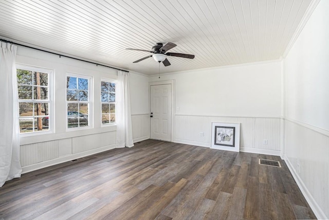 empty room with dark hardwood / wood-style flooring, wooden ceiling, ceiling fan, and crown molding