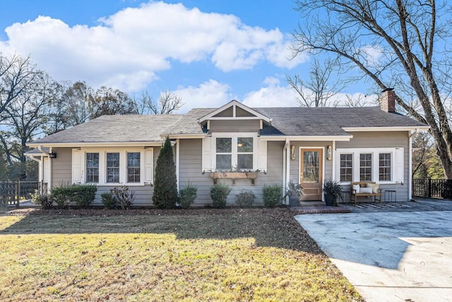 ranch-style home with a front yard