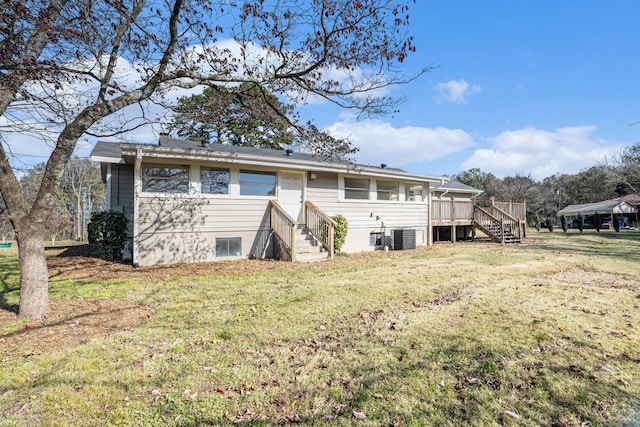 back of property featuring a lawn, cooling unit, and a deck