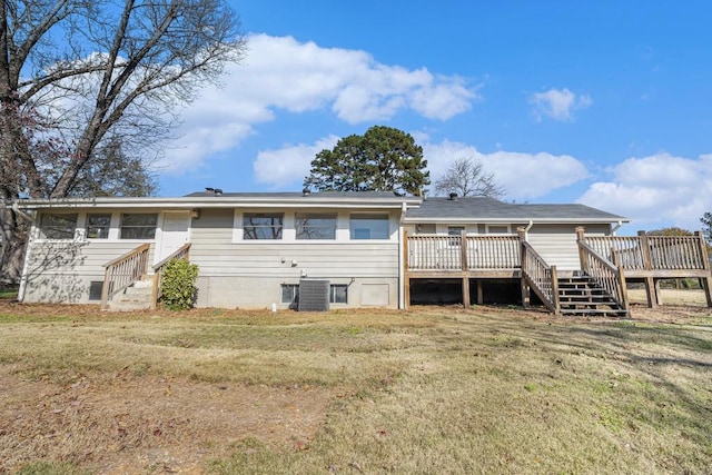 rear view of house featuring a yard, central AC unit, and a deck