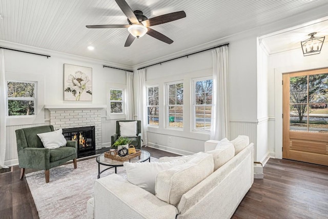 living room featuring a wealth of natural light and dark wood-type flooring