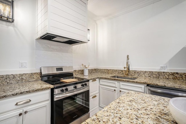 kitchen with white cabinetry, sink, light stone countertops, crown molding, and appliances with stainless steel finishes