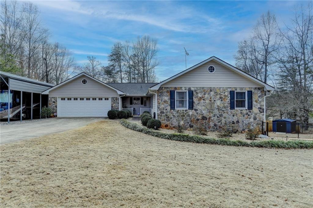 ranch-style house featuring a carport and a garage