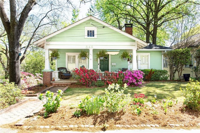 bungalow-style house featuring a front yard and a porch