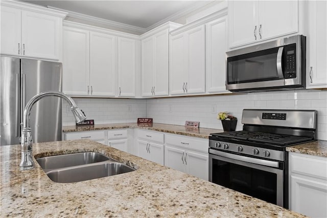 kitchen with sink, white cabinets, and stainless steel appliances