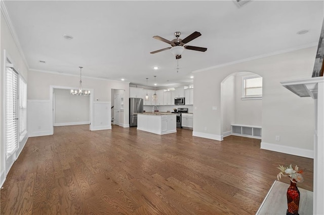 unfurnished living room with wood-type flooring and crown molding