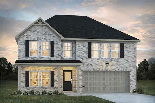 view of front of property featuring a garage, a lawn, concrete driveway, and brick siding