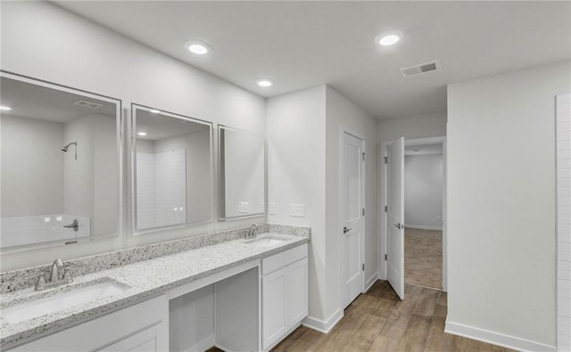 bathroom with vanity and hardwood / wood-style flooring