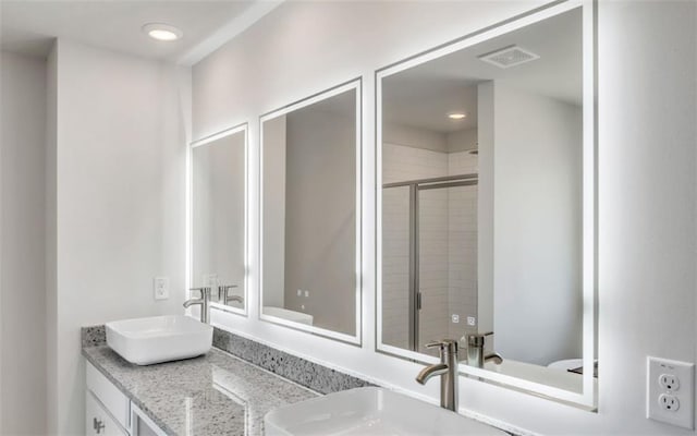 bathroom featuring vanity and an enclosed shower