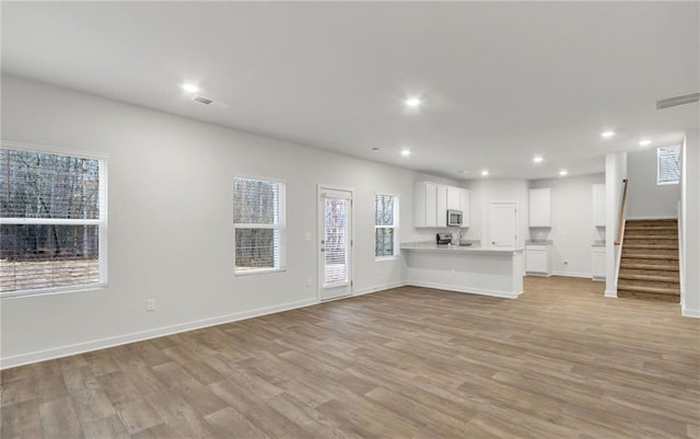 unfurnished living room featuring light hardwood / wood-style floors