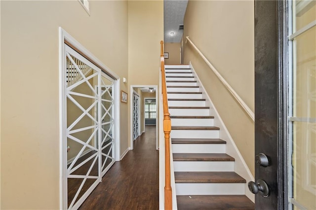152 Maxton Ave, Dallas, GA 30132 - stairs featuring wood finished floors, a towering ceiling, and baseboards