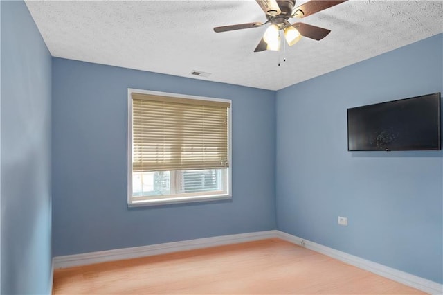 152 Maxton Ave, Dallas, GA 30132 - spare room featuring wood finished floors, a textured ceiling, a ceiling fan, and baseboards