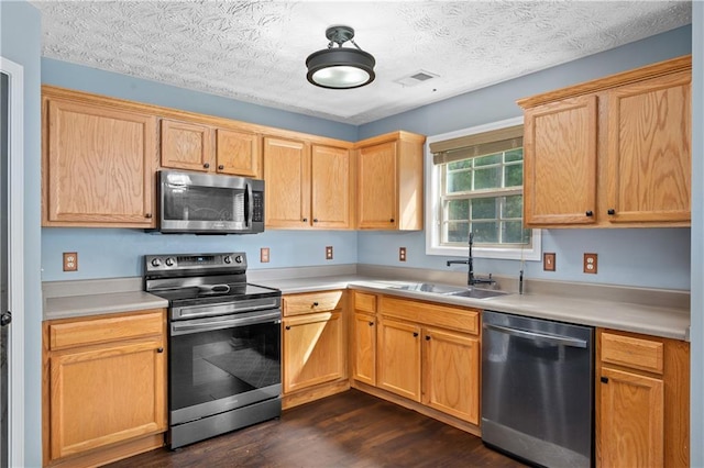 152 Maxton Ave, Dallas, GA 30132 - kitchen featuring stainless steel appliances, a sink, dark wood-style flooring, light countertops, and a textured ceiling