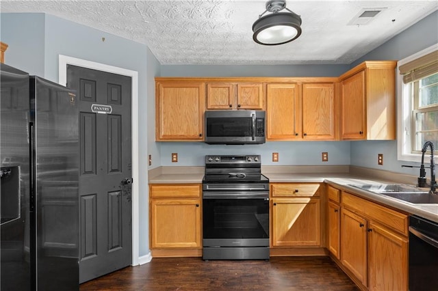 152 Maxton Ave, Dallas, GA 30132 - kitchen featuring stainless steel appliances, a sink, dark wood-style floors, and light countertops