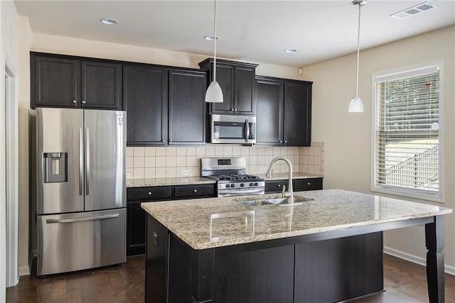3013 Nicholas Dr, Villa Rica, GA 30180 - kitchen with appliances with stainless steel finishes, a sink, tasteful backsplash, an island with sink, and recessed lighting