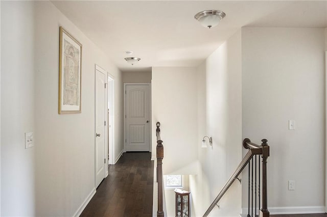 3013 Nicholas Dr, Villa Rica, GA 30180 - corridor featuring an upstairs landing, baseboards, and dark wood finished floors