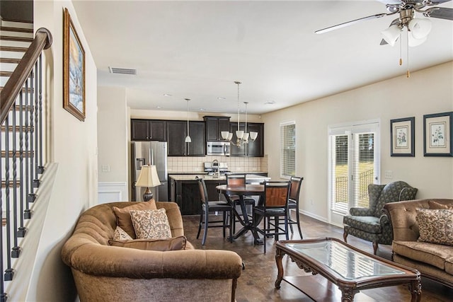 3013 Nicholas Dr, Villa Rica, GA 30180 - living area featuring a ceiling fan, a chandelier, and stairway