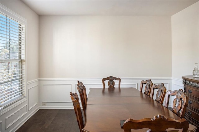 3013 Nicholas Dr, Villa Rica, GA 30180 - dining space featuring dark wood-type flooring, wainscoting, and a decorative wall