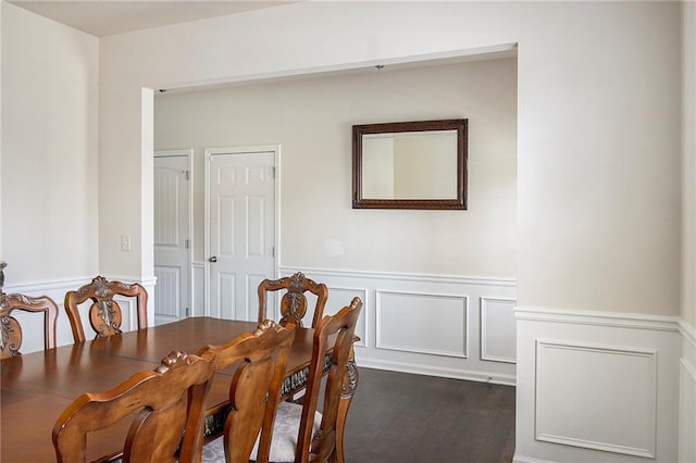3013 Nicholas Dr, Villa Rica, GA 30180 - dining space featuring dark wood-style floors, wainscoting, and a decorative wall