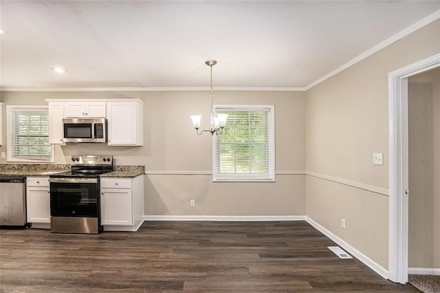 kitchen with visible vents, crown molding, appliances with stainless steel finishes, white cabinets, and a chandelier