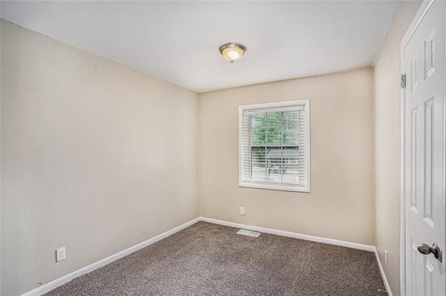 carpeted empty room with baseboards and visible vents