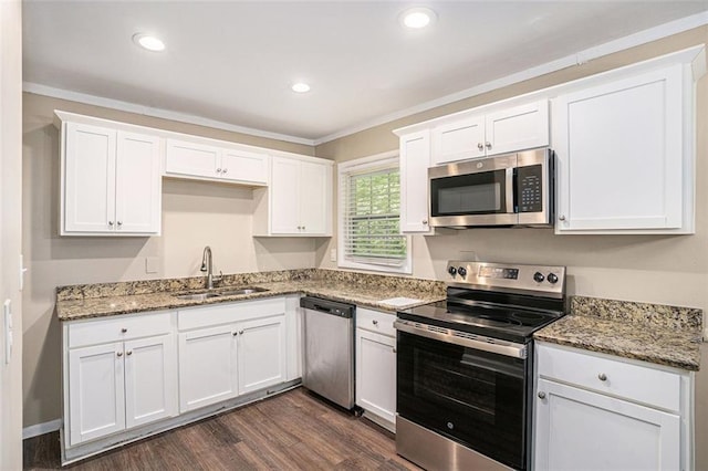 kitchen featuring appliances with stainless steel finishes, light stone countertops, dark wood finished floors, a sink, and white cabinets