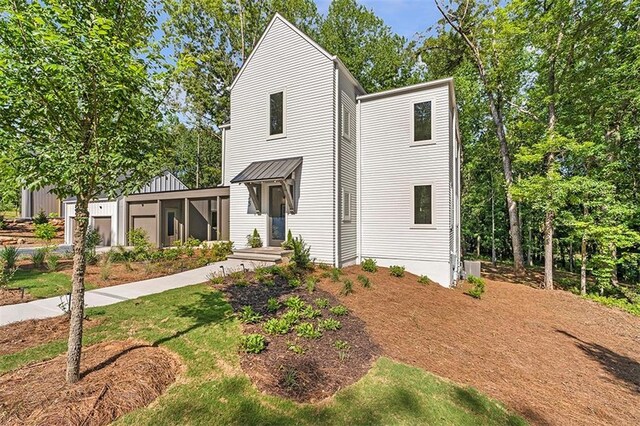 135 Cedarwood Ln, Roswell, GA 30075 - modern inspired farmhouse featuring metal roof, a standing seam roof, and a sunroom